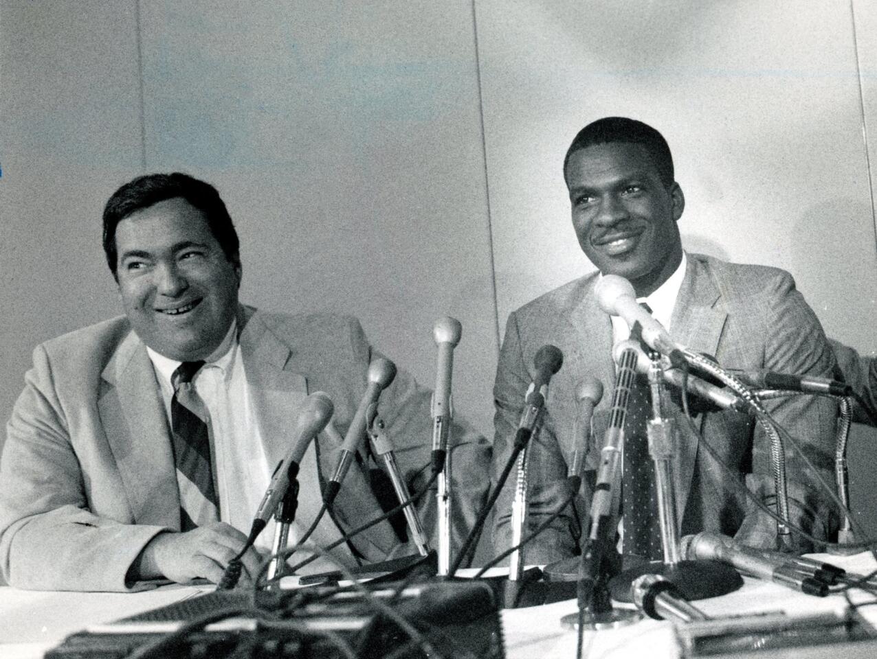 (Sept. 26, 1985) Bull' vice president Jerry Krause shares a laugh with Charles Oakley at a press conference on Sept. 26, 1985. Oakley signed a three-year contract.