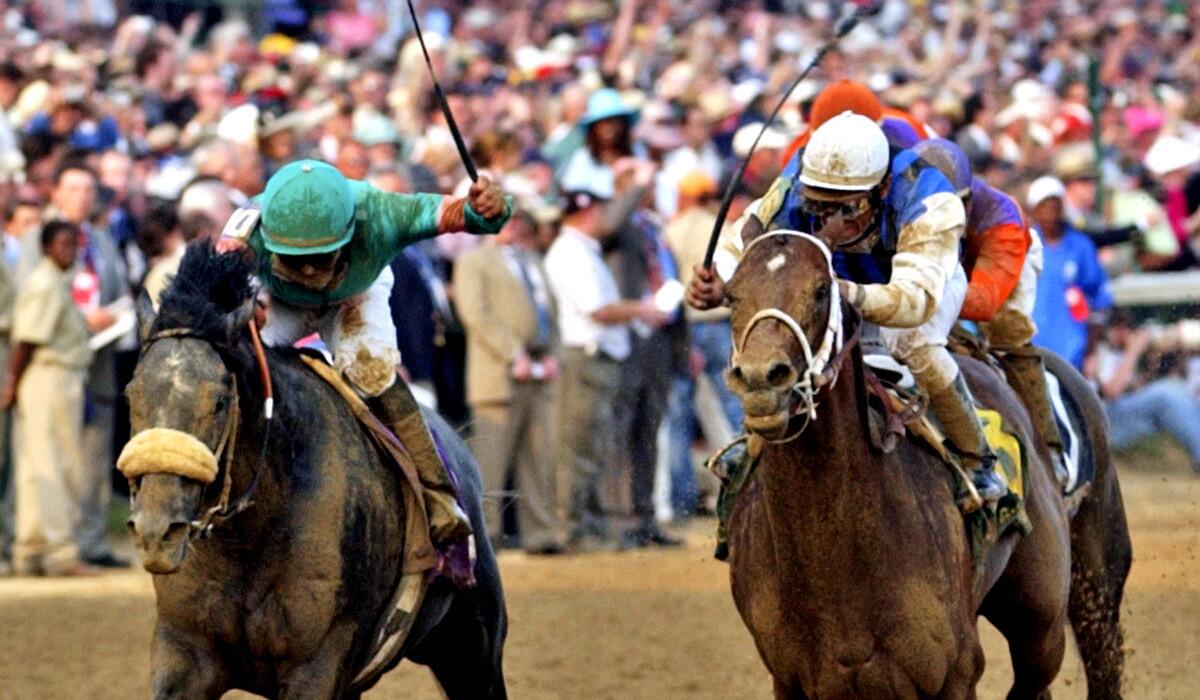Jockeys use their whips during the stretch run of the 131st Kentucky Derby in 2005.