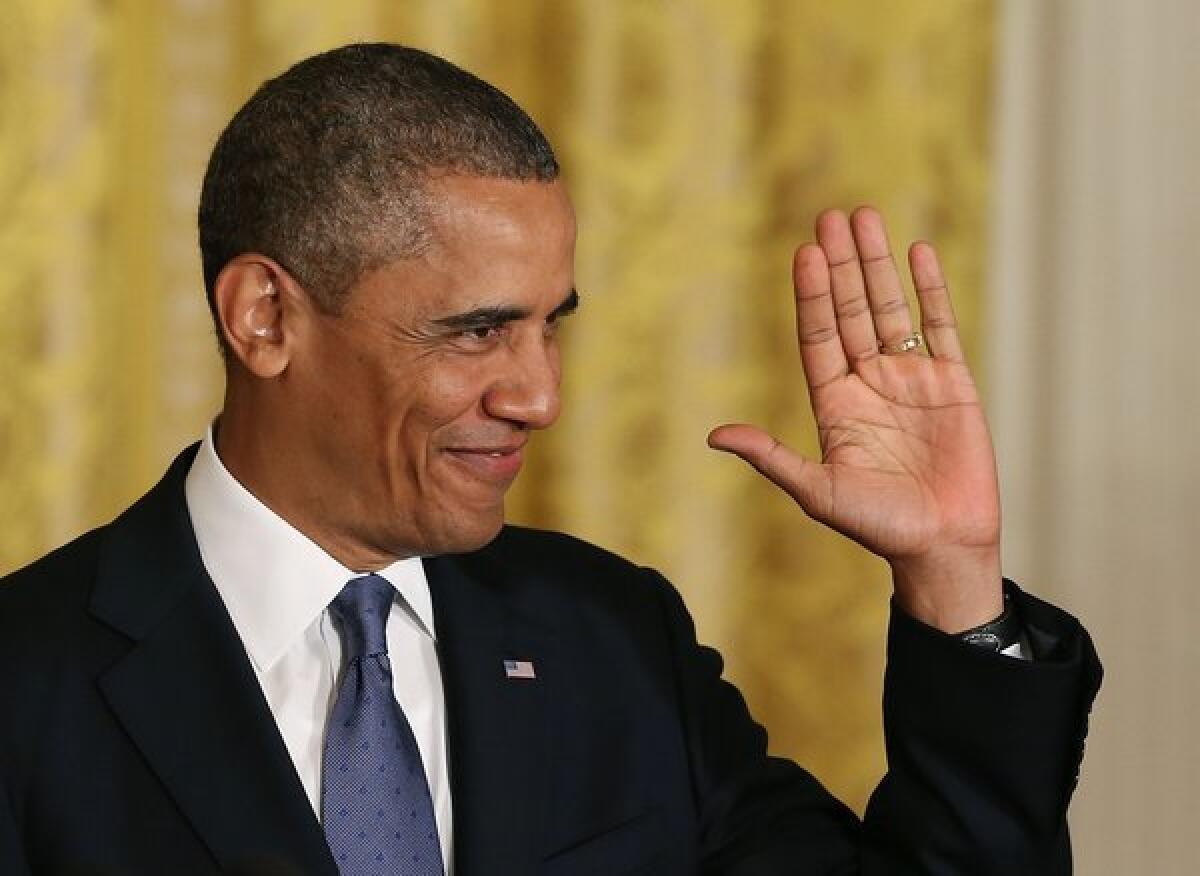 President Obama gestures to the audience before speaking about the Affordable Healthcare Act in the East Room of the White House on July 18, 2013.