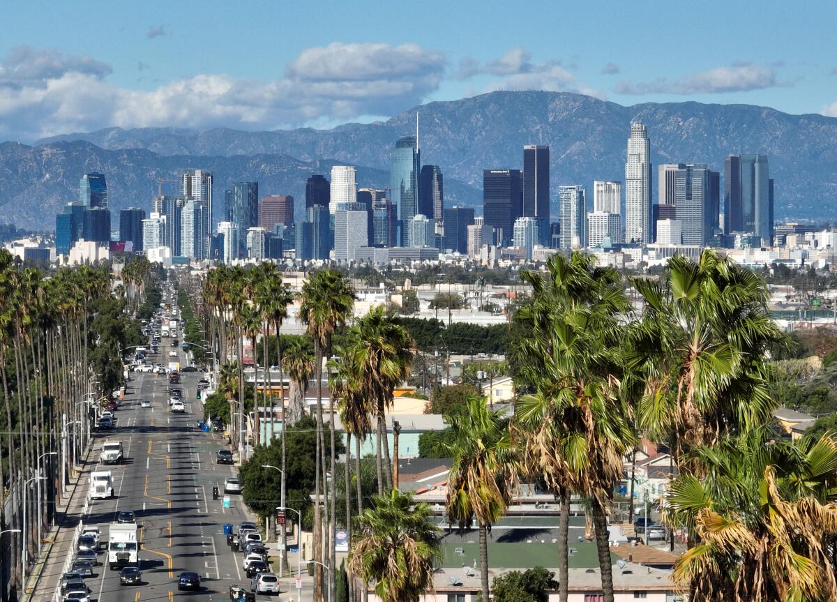 A clear view of downtown Los Angeles and the mountains.