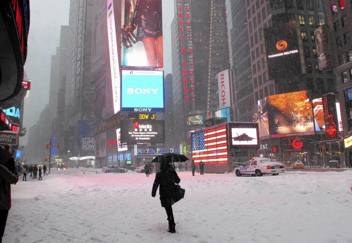 This winter, bitter cold and heavier-than-normal snowfall swept across much of the nation, chilling economic activity. Above, New York residents endure harsh weather last February.