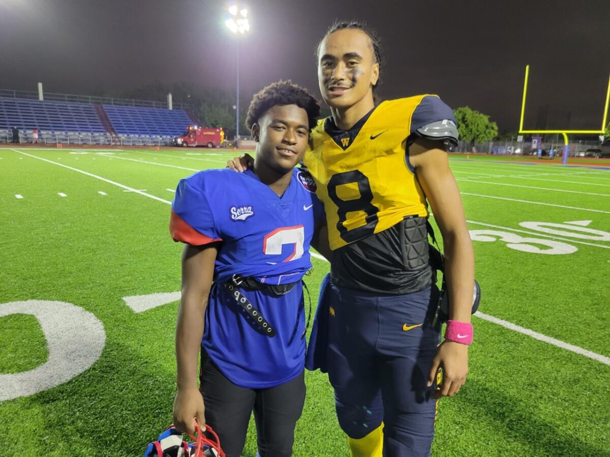 Rodrick Pleasant of Gardena Serra and quarterback Nico Iamaleava of Warren pose for a photo.