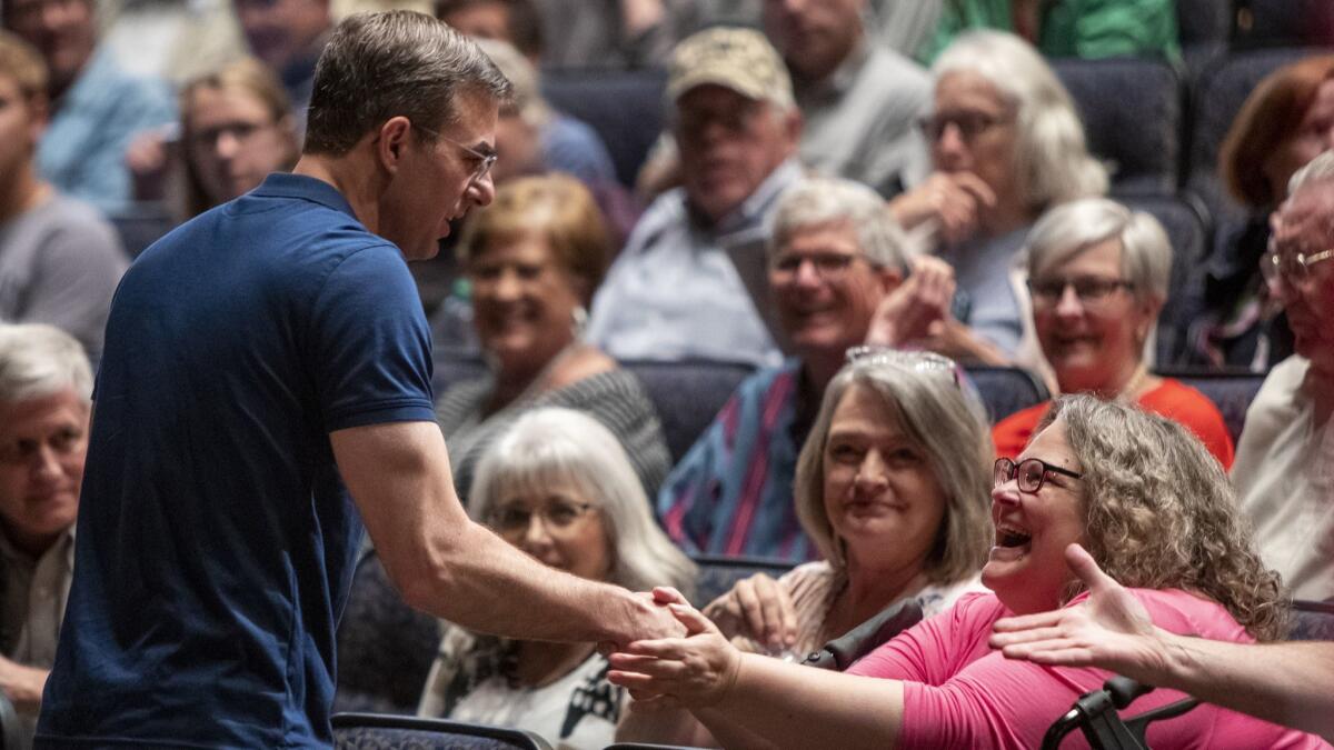 Rep. Justin Amash (R-Michigan) greets the crowd before holding a town hall meeting at Grand Rapids Christian High School's DeVos Center for Arts and Worship on May 28.