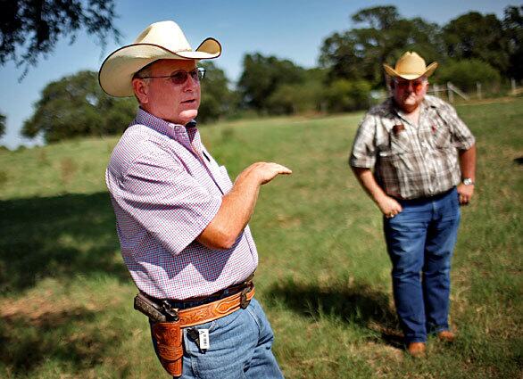 Livestock theft investigator Troy McKinney, left, talks with bookkeeper Al Croix of the Supreme Farms ranch, which has had 122 prime Angus cattle stolen over the last year. The case in Denton, Texas, is one of several McKinney is looking into.