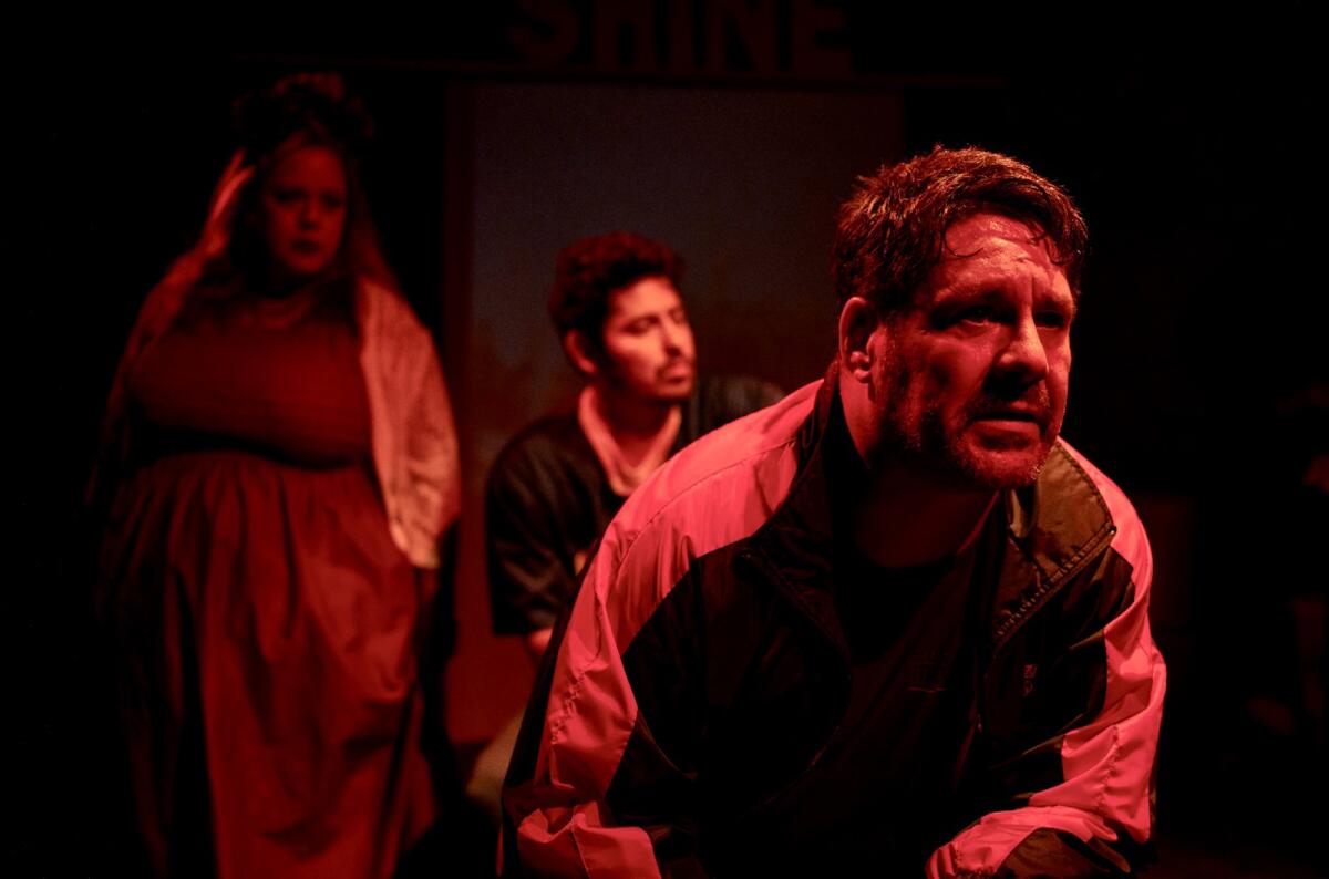 Vanessa Lopez, John Carroll and Paul Araujo (foreground) in "Mugre" at OnStage Playhouse in Chula Vista.