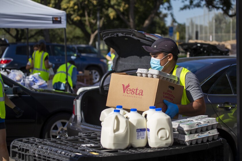 A monthly drive-thru food distribution at Mile Square Park on Wednesday, Oct. 14, 2020 in Fountain Valley, CA.