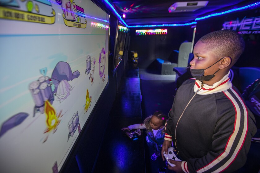 Will California's small businesses survive another COVID-19
surge without more help? 3 Romari Mallard, 10, volunteers as a game coach for his family's business.
