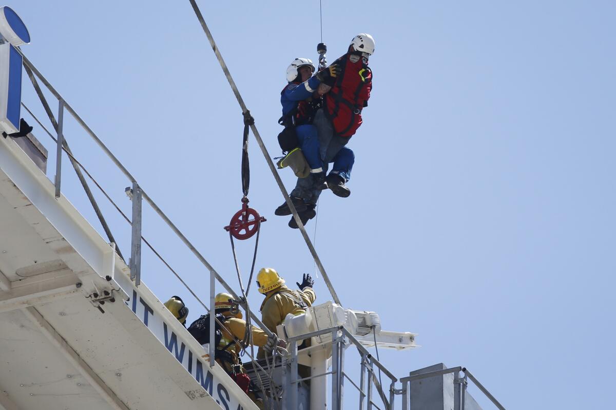 A crane worker is rescued Thursday.