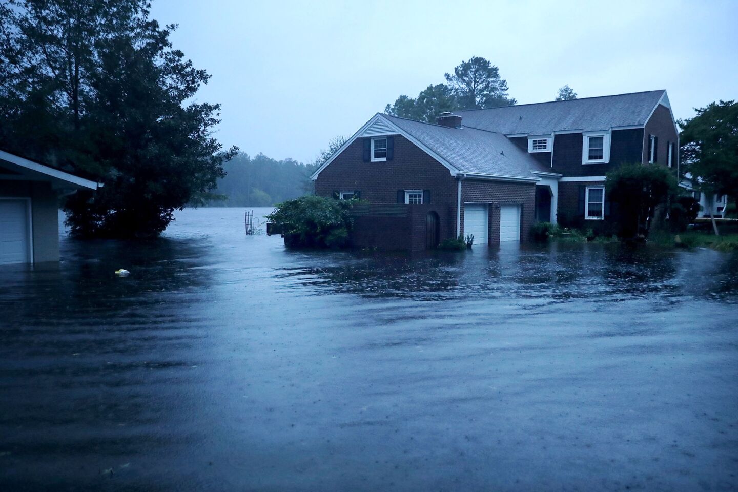 The Trent River (background) overflows its banks and floods a neighborhood during Hurricane Florence in River Bend, N.C.