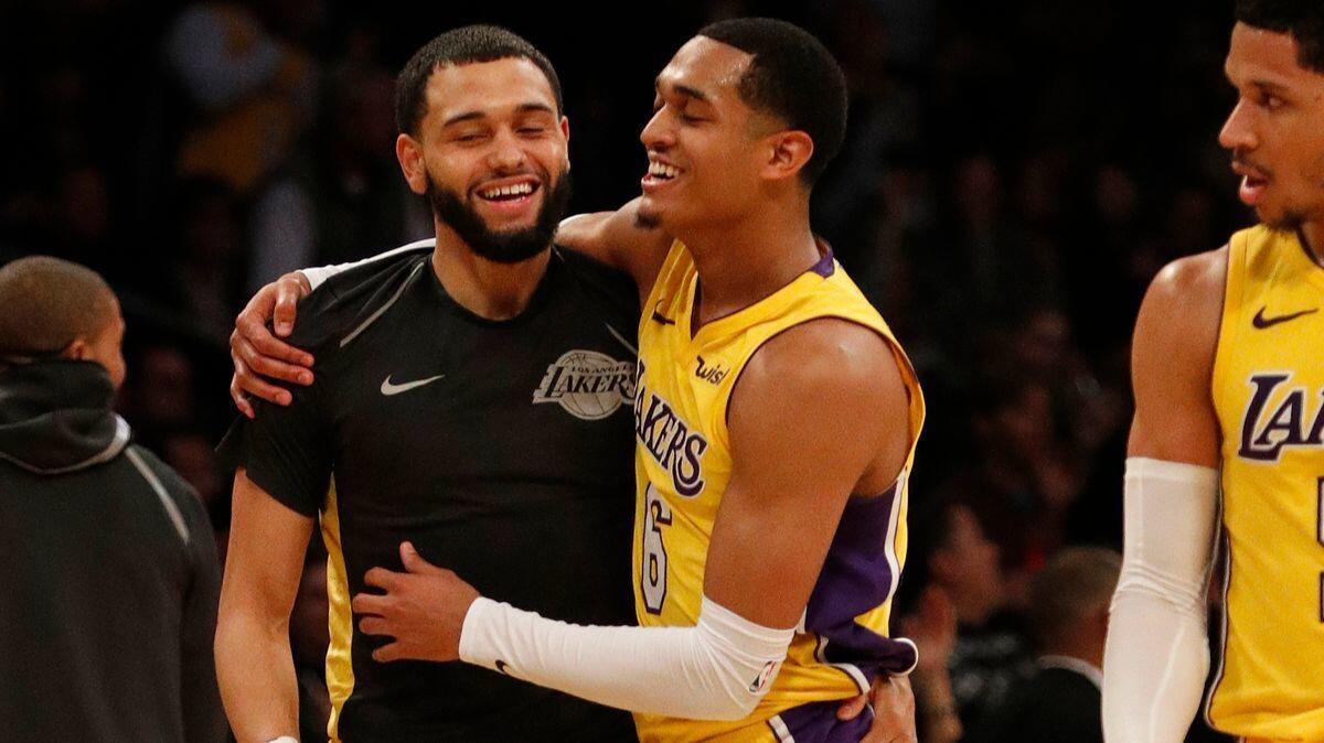 Lakers guard Jordan Clarkson (6) gets a hug from teammate Tyler Ennis (10) after his three-pointer seals the win against the Indiana Pacers at Staples Center on Jan. 19.