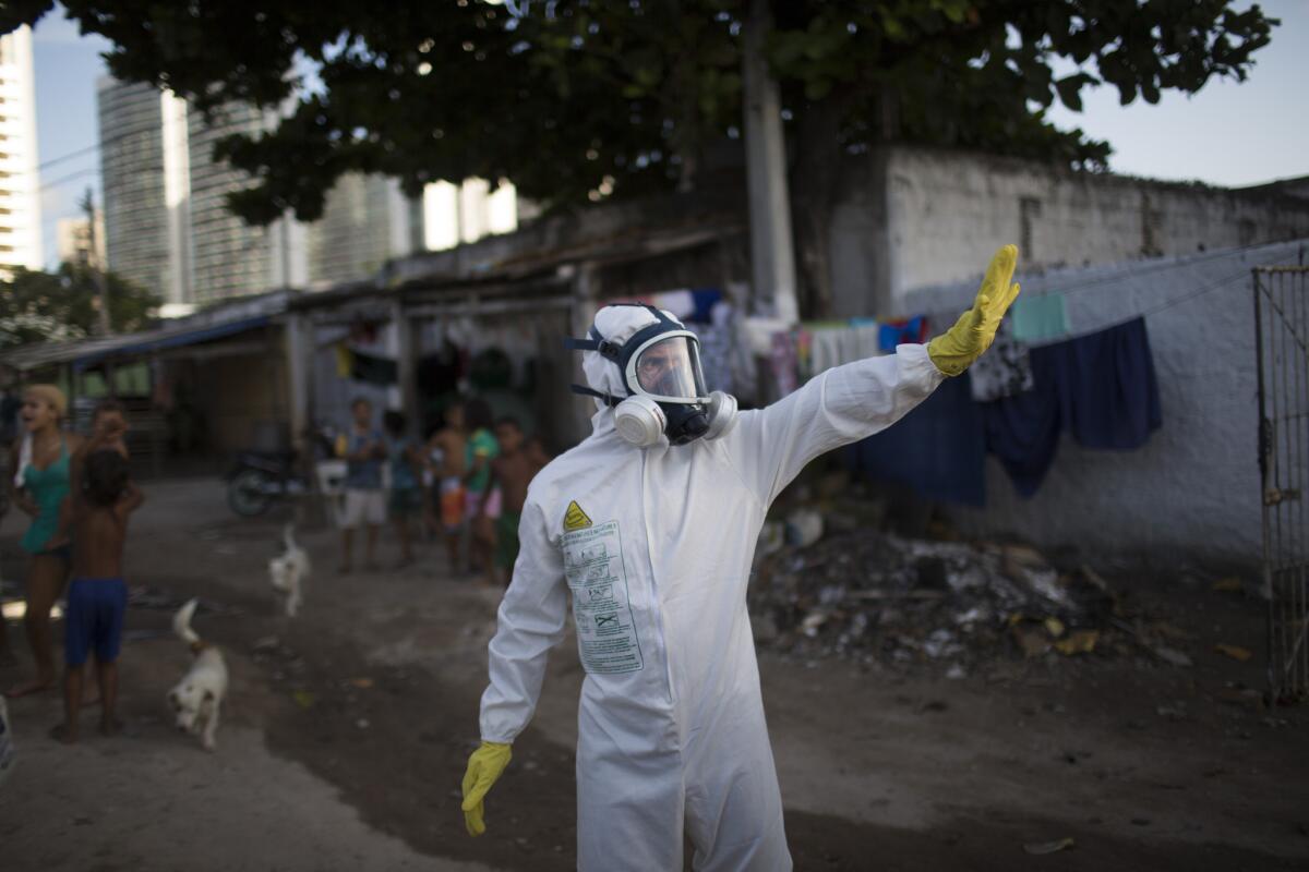 A municipal worker gestures during an operation in Recife, Brazil, to combat mosquitoes that transmit the Zika virus.