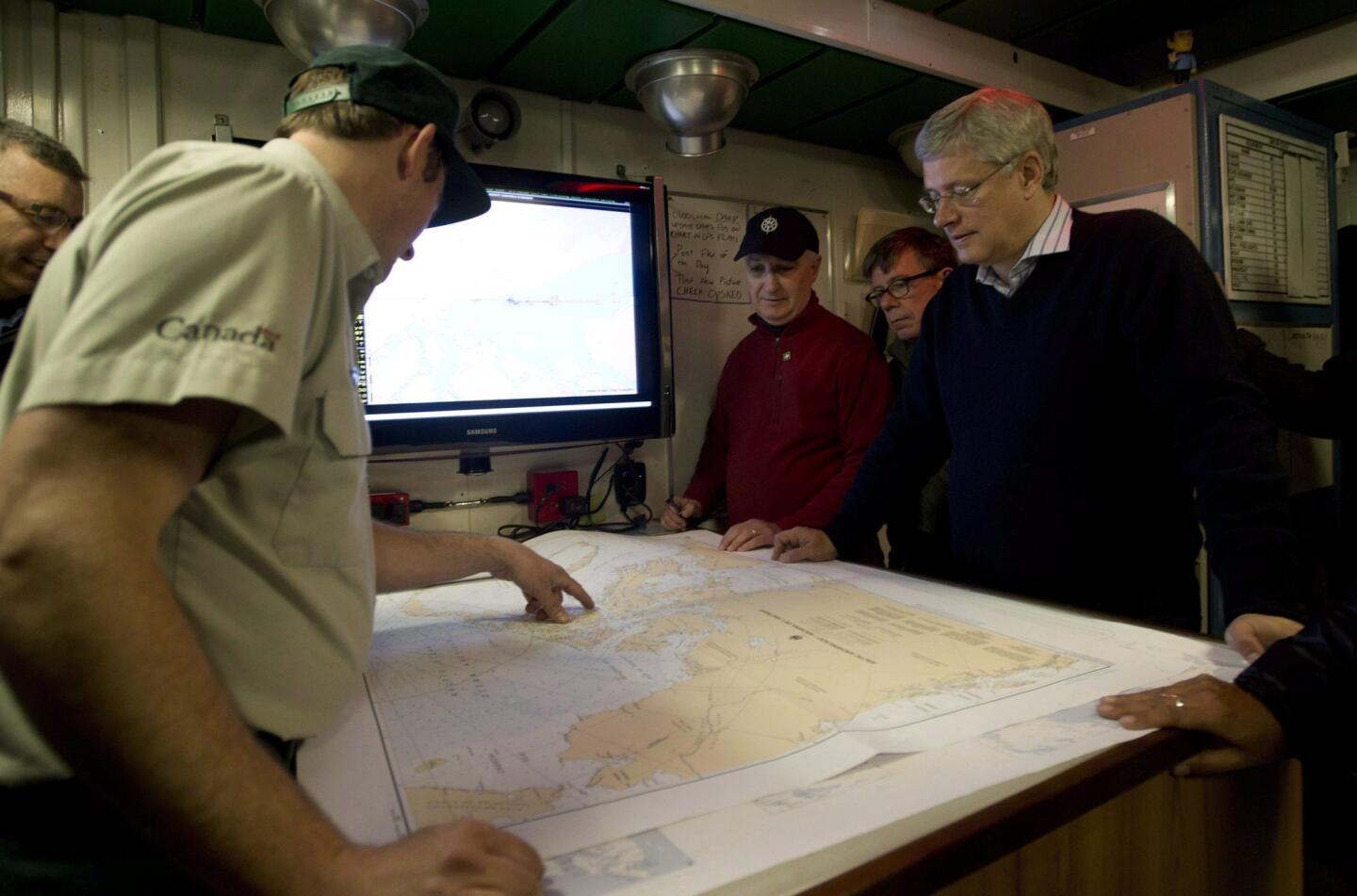 Ryan Harris of Parks Canada, left, briefs Canadian Prime Minister Stephen Harper on efforts to find the Franklin expedition aboard the search ship Kingston in the Arctic. The two ships, the Erebus and the Terror, disappeared in the late 1840s.