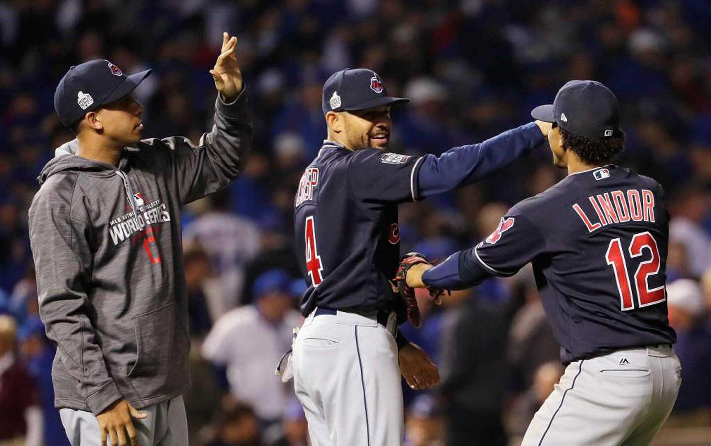 Coco Crisp #4 and Francisco Lindor #12 of the Cleveland Indians celebrate after beating the Chicago Cubs 1-0 in Game Three of the 2016 World Series at Wrigley Field on October 28, 2016 in Chicago, Illinois.