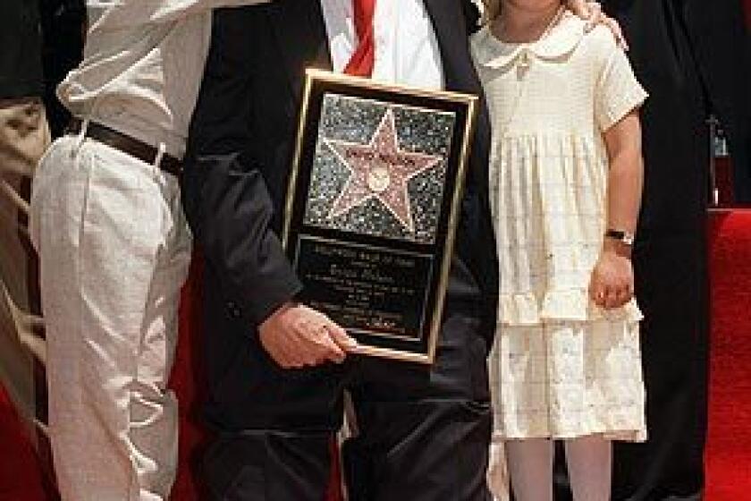 Actor David Nelson poses with his grandson, Michael Woolery, and family friend Ashley Holt as he is honored with the 2,065th star on the Hollywood Walk of Fame on May 9, 1996. Nelson, who starred on his parents' popular television show, "The Adventures of Ozzie and Harriet, " died in Los Angeles on Tuesday. He was 74. See full story