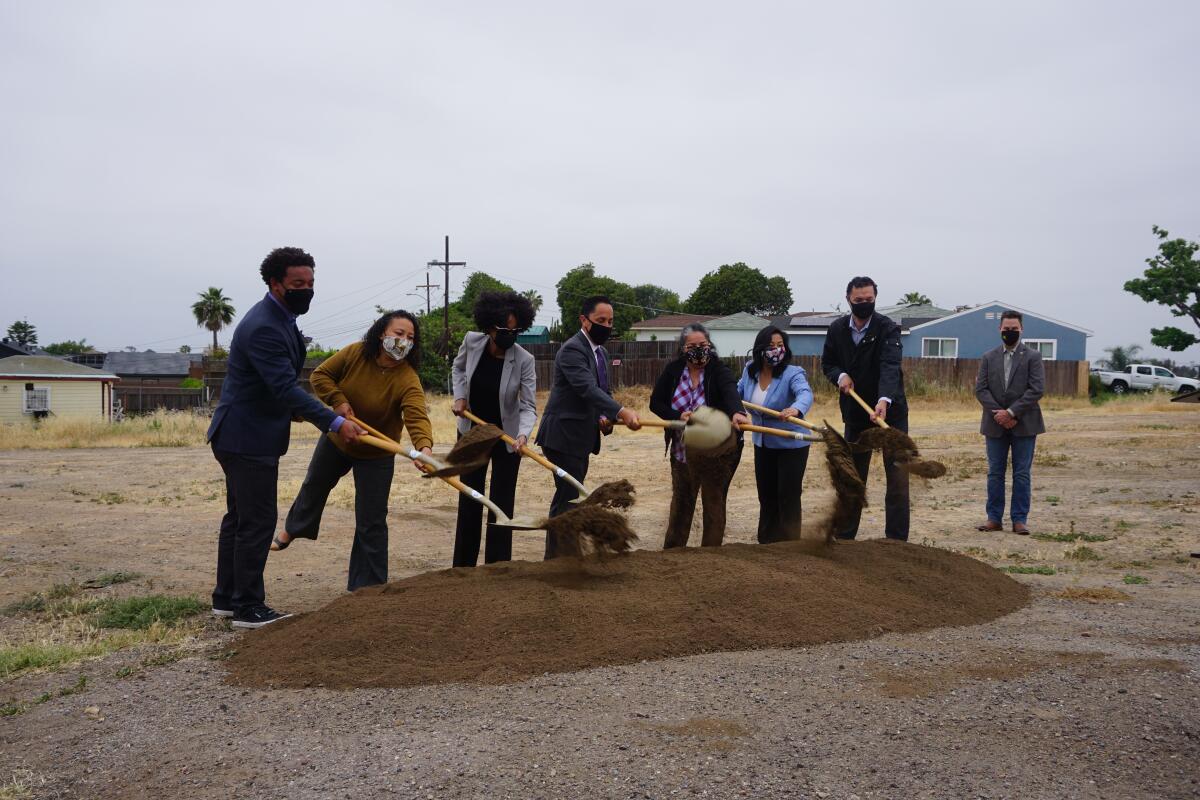 San Diego elected officials, city staff members and residents holding shovels in Valencia Park on May 11, 2021.