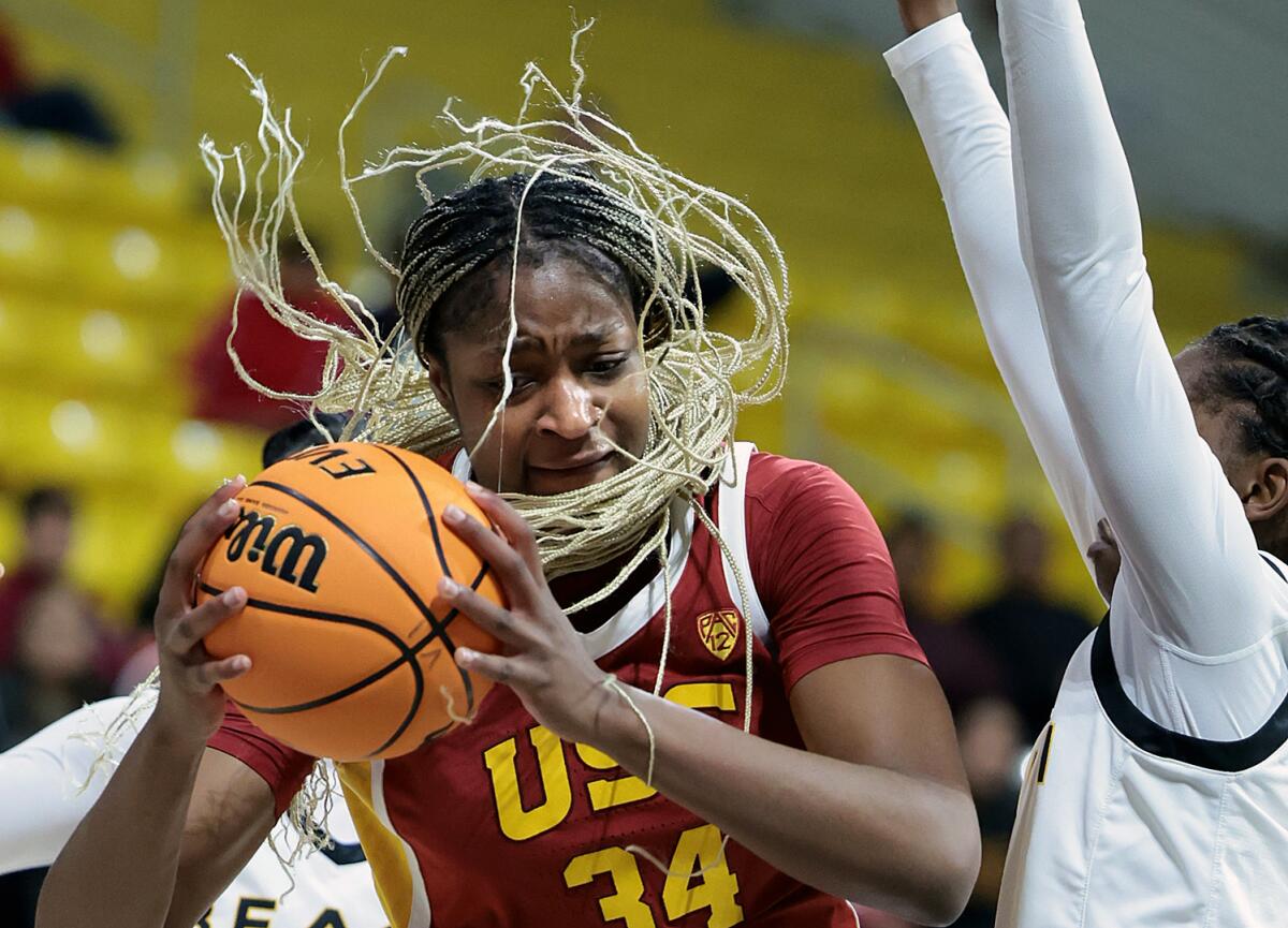 USC's Clarice Akunwafo drives past Long Beach State's Lovely Sonnier in the first quarter Thursday.