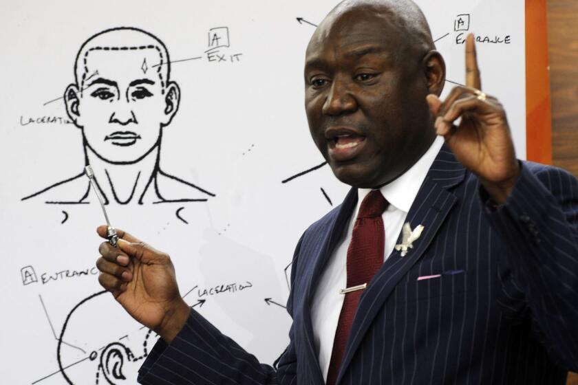 Attorney Ben Crump discusses the results of a forensic examination on Emantic "EJ" Bradford Jr., who was fatally shot by police in a shopping mall on Thanksgiving day, during a news conference in Birmingham, Ala., on Monday, Dec. 3, 2018. Crump, who represents Bradford's family, says a report shows the 21-year-old black man suffered three gunshot wounds to the back side of his body. (AP Photo/Jay Reeves)