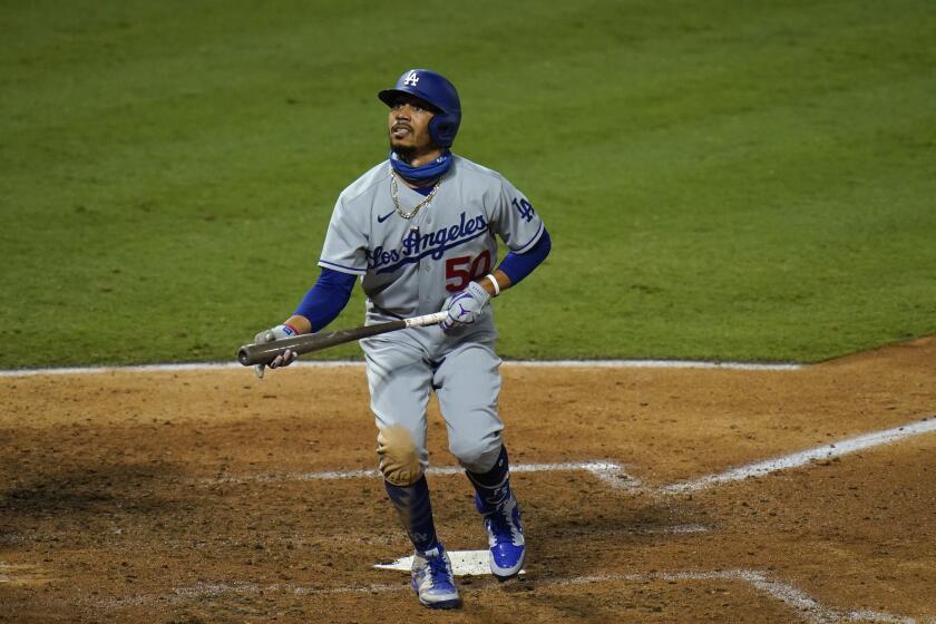 The Dodgers' Mookie Betts watches his foul ball during the seventh inning against the Angels on Aug. 14, 2020.