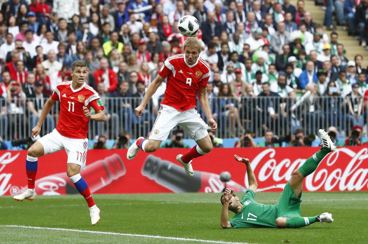 Russia's Yuri Gazinsky heads the ball to score the opening goal against Saudi Arabia to open the 2018 World Cup on June 14 in Moscow.