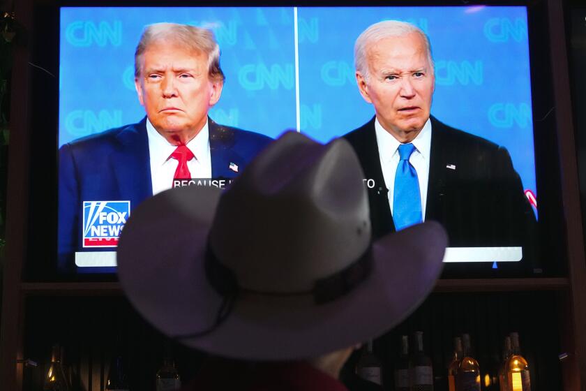 Roger Strassburg, of Scottsdale, Ariz., wears a cowboy hat as he watches the presidential debate between President Joe Biden and Republican presidential candidate former President Donald Trump at a debate watch party Thursday, June 27, 2024, in Scottsdale, Ariz. (AP Photo/Ross D. Franklin)