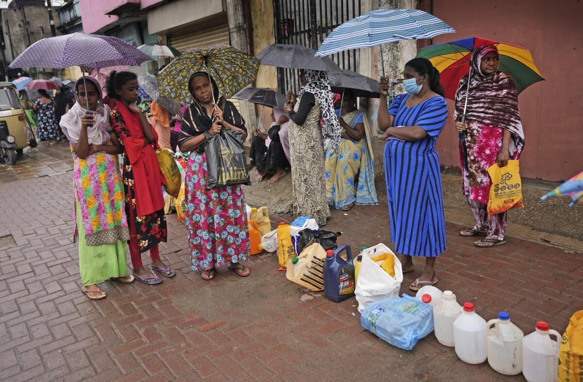 Women wait in a queue to buy kerosene in Colombo, Sri Lanka