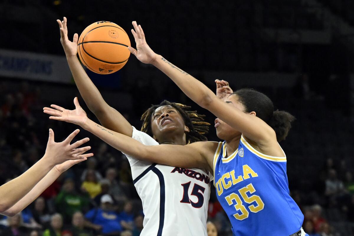 Arizona guard Kailyn Gilbert, left, and UCLA guard Camryn Brown battle for the ball.