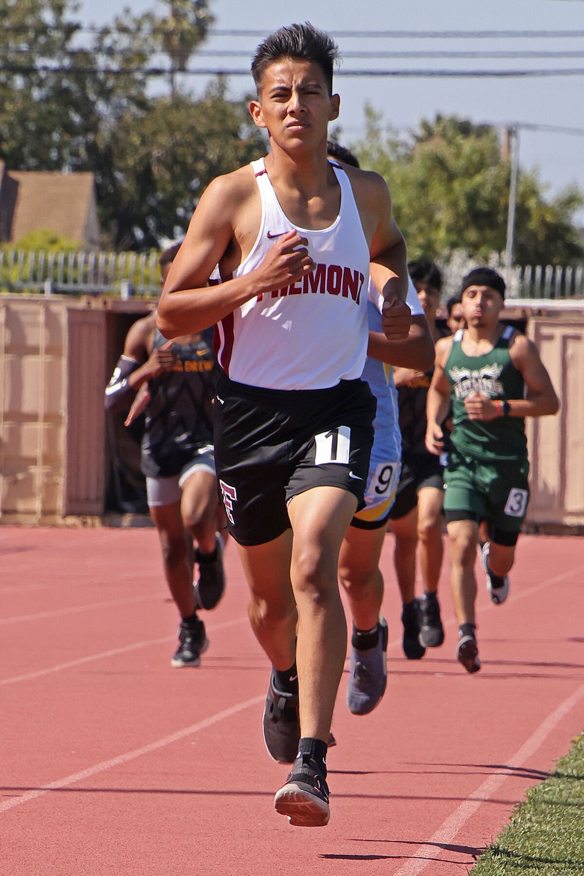 Edgar Vazquez of Fremont High runs in a race ahead of other competitors.