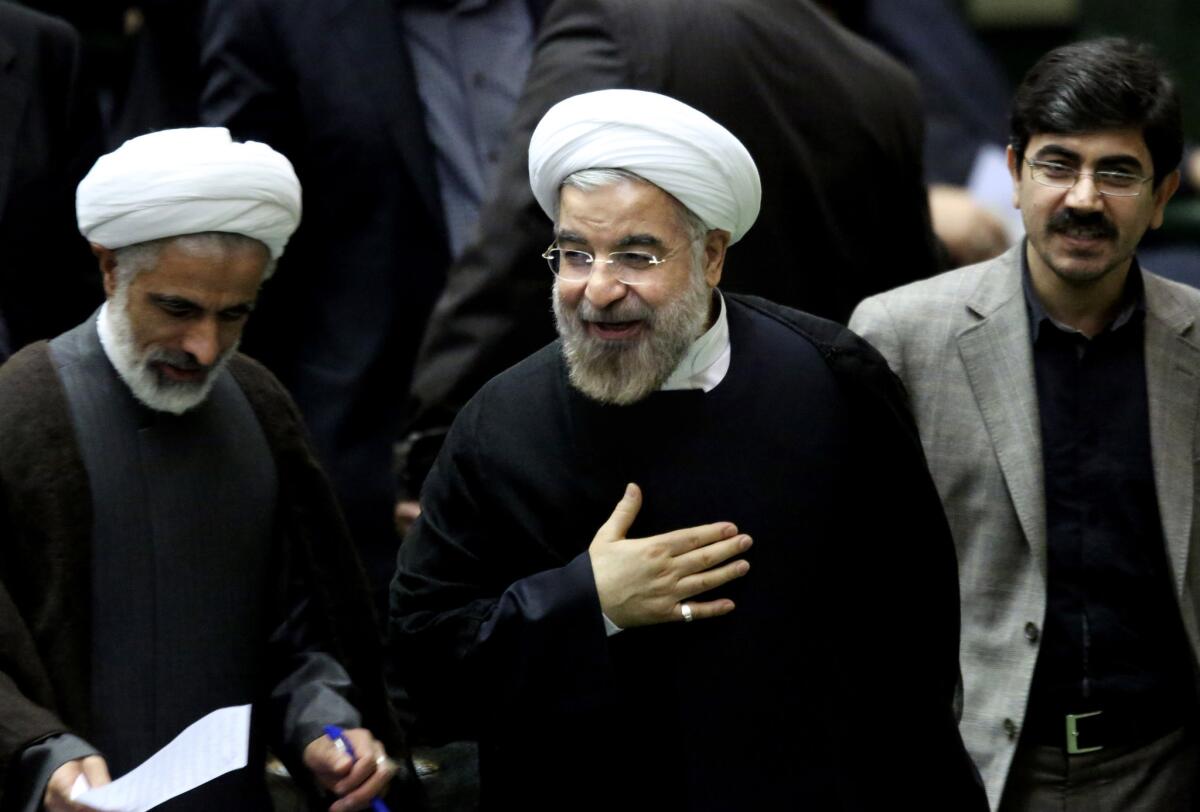Iranian President Hassan Rouhani, center, is shown Sunday after leaving a session of parliament in Tehran.