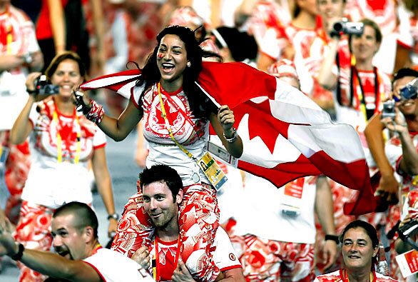 An energetic group of Canadian athletes enjoy their time on the National Stadium field during the 2008 Beijing Olympics closing ceremony.