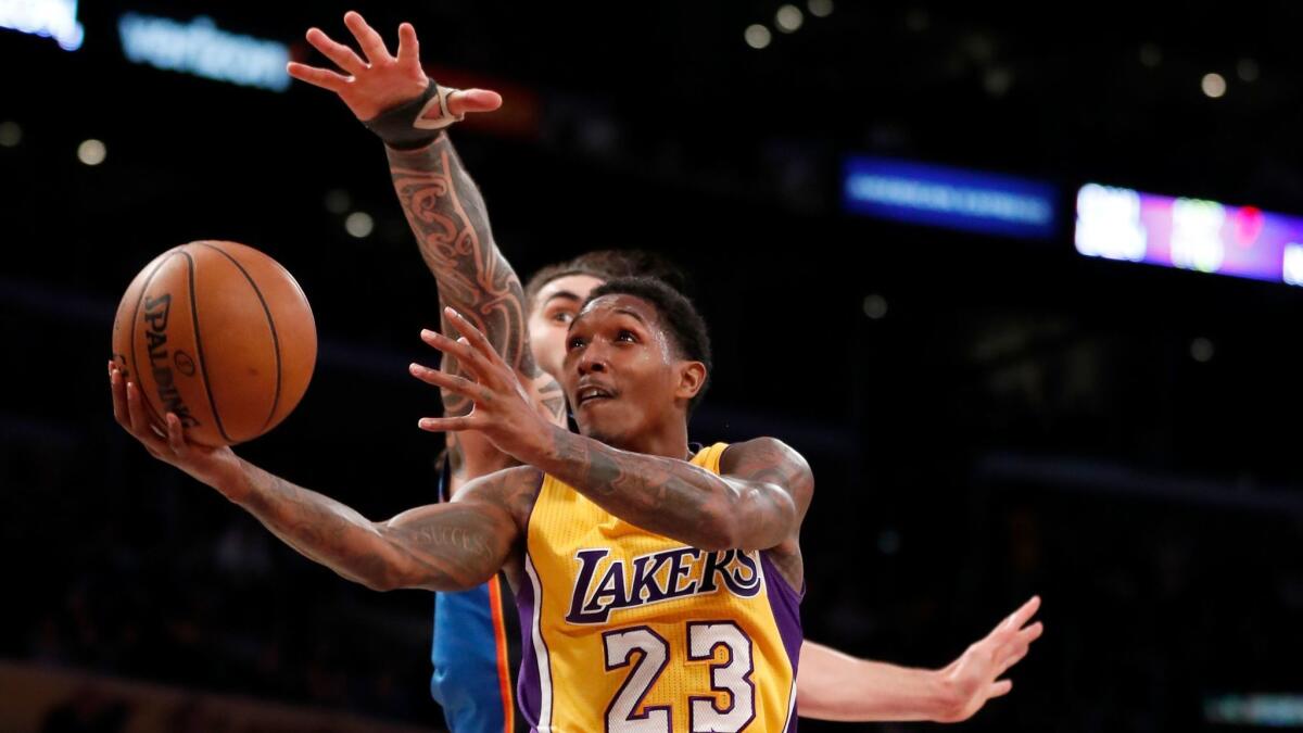 Lakers guard Lou Williams goes to the basket in front of Oklahoma City's Steven Adams on Nov. 22.