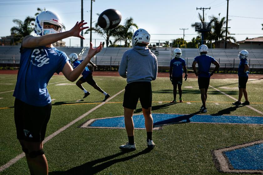 CULVER CITY, CA - FEBRUARY 26: Quarterbacks and Receivers at Culver City High School work on drills its first official football practice after an 11-month shutdown due to Covid-19 on {wdt} in Culver City, CA. (Jason Armond / Los Angeles Times)