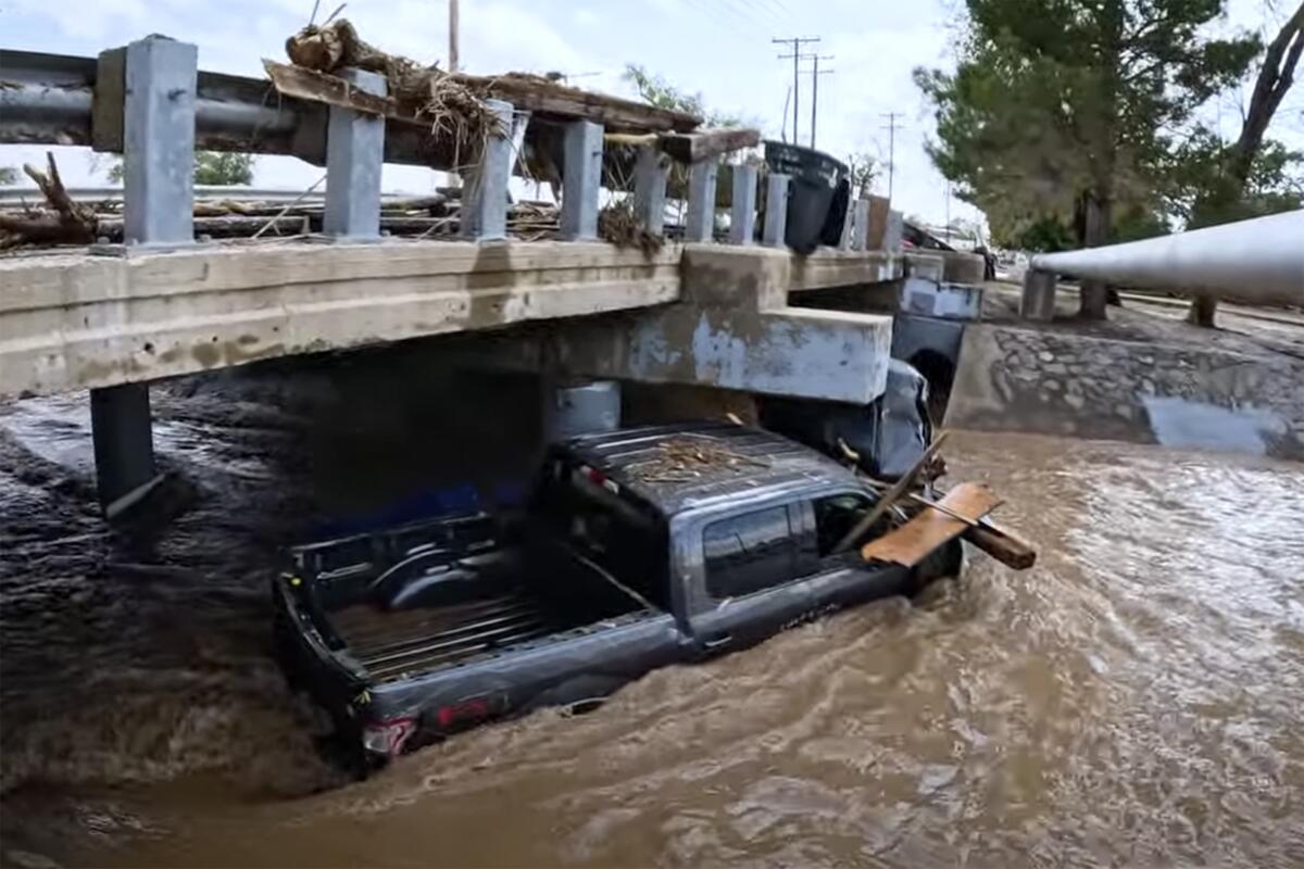 In this image taken from video, debris and damage and are seen from severe flooding in Roswell, N.M.