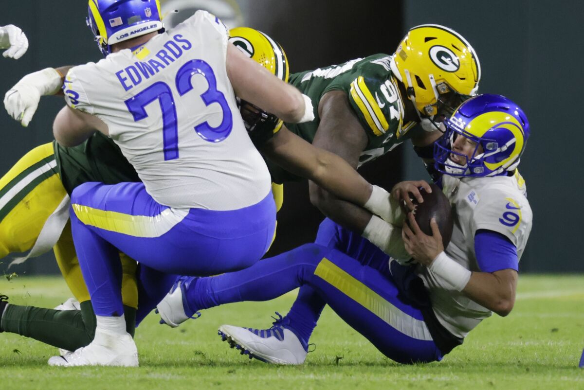Green Bay Packers' Kenny Clark sacks Los Angeles Rams' Matthew Stafford during the second half of an NFL football game Sunday, Nov. 28, 2021, in Green Bay, Wis. (AP Photo/Matt Ludtke)
