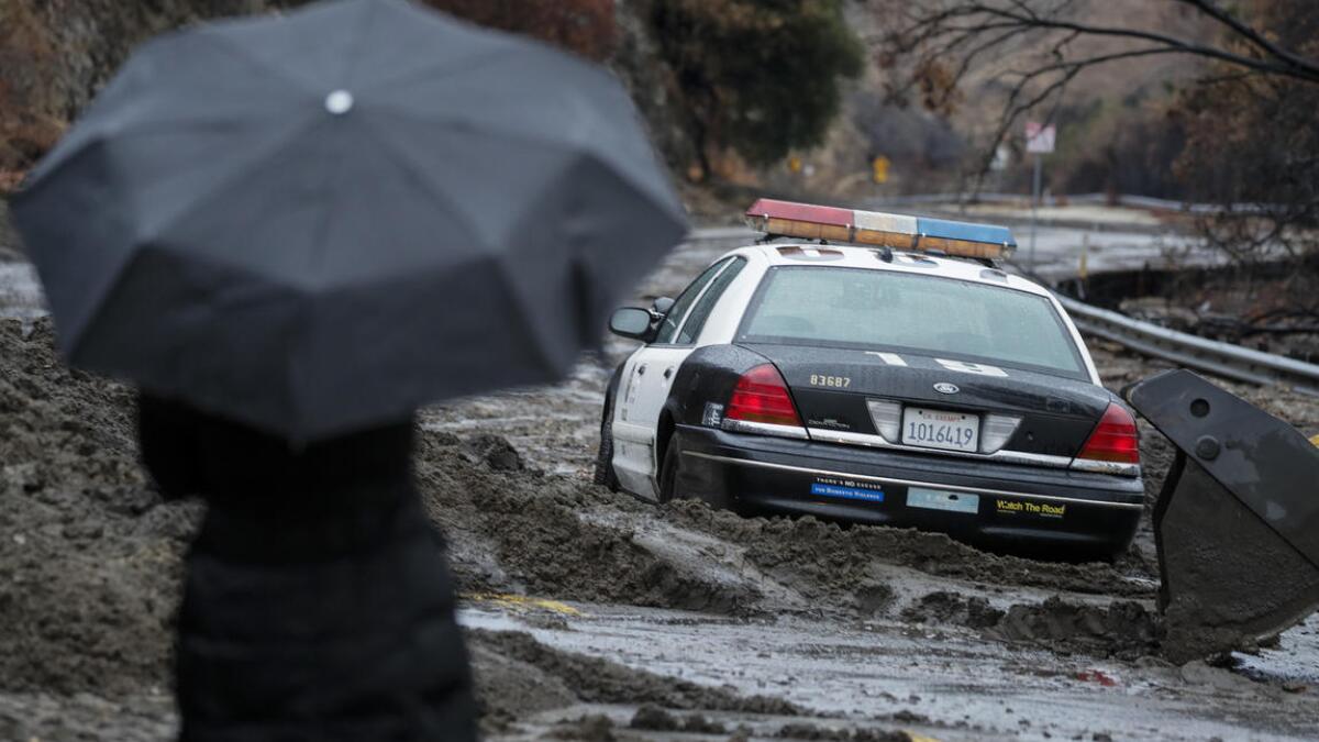 A Los Angeles Police Department car stuck in the mud on La Tuna Canyon Road.
