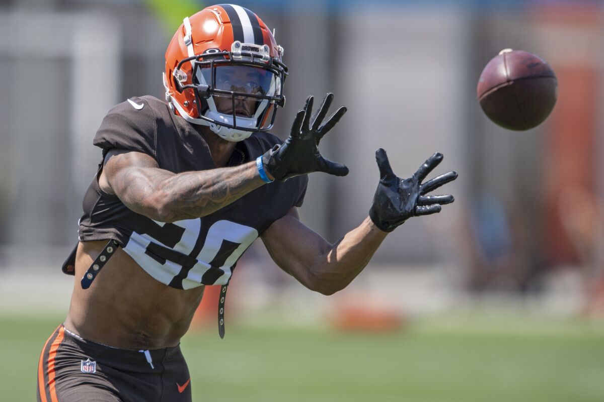 Cleveland Browns defensive back Greg Newsome II catches a football during an NFL football practice in Berea, Ohio, Wednesday, Aug. 4, 2021. (AP Photo/David Dermer)