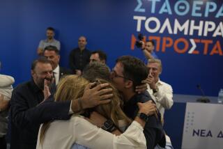 Kyriakos Mitsotakis leader of center-right New Democracy hugs his family at the headquarters of the party in Athens, Greece, Sunday, June 25, 2023. Greece's conservative New Democracy party has won a landslide victory in the country's second election in five weeks, with partial official results showing it gaining a comfortable parliamentary majority to form a government for a second four-year term. (AP Photo/Petros Giannakouris)