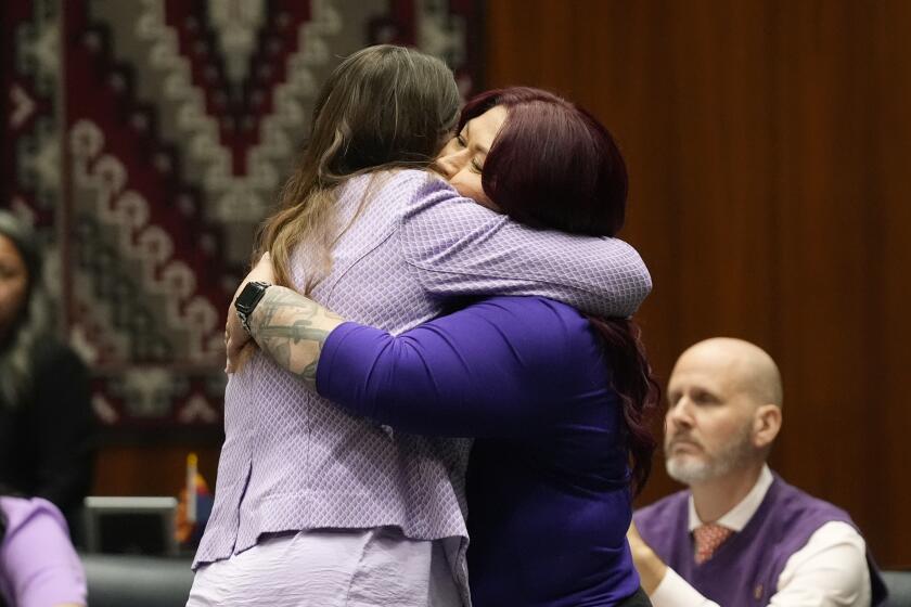 Arizona Rep. Stephanie Stahl Hamilton, D-Tucson, left, gets a hug from Sen. Anna Hernandez, D-Phoenix, after the vote tally on the proposed repeal of Arizona's near-total ban on abortions winning approval from the state House Wednesday, April 24, 2024, in Phoenix. (AP Photo/Ross D. Franklin)