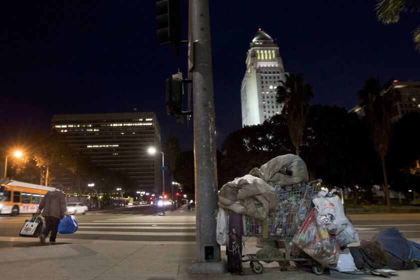 LOS ANGELES, CA January 29, 2018: A person sleeps on the corner of First and N Spring Street, across the street from City Hall in Los Angeles, CA November 15, 2017. The number of those living in the streets and shelters of Los Angeles City and County surged 75 % â to 55,000 from 32,000 â in the last six years. (Including Glendale, Pasadena and Long Beach, which conduct their own counts, the countywide total is nearly 58,000.) (Francine Orr/ Los Angeles Times)
