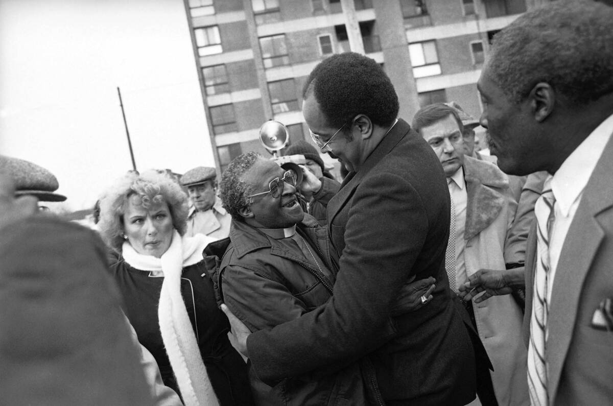 Bishop Desmond Tutu, left, is greeted by Rep. William H. Gray III, who had just returned from a trip to South Africa, outside Philadelphia's Bright Hope Baptist Church in 1986. Gray, who has died at 71, fought for anti-apartheid sanctions in Congress.