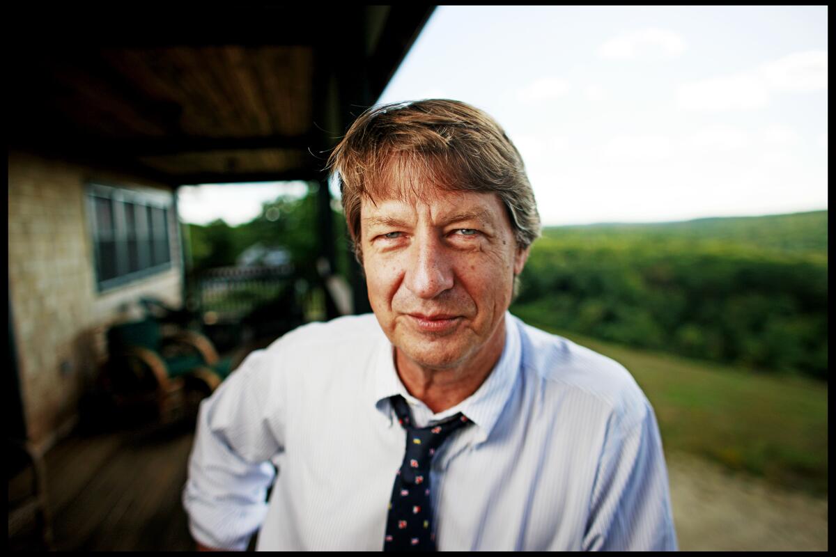 A portrait of author P.J.O'Rourke at home in a shirt and tie.