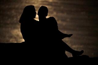 FILE - In this June 27, 2018, file photo a couple is silhouetted against moonlight reflecting off the Missouri River as they watch the full moon rise beyond downtown buildings in Kansas City, Mo. Money can create stress within a relationship, but talking through expectations and money beliefs can help couples get on the same page. In fact, conflict over money can be healthy, partly because we often partner with people who are our financial opposites. (AP Photo/Charlie Riedel, File)