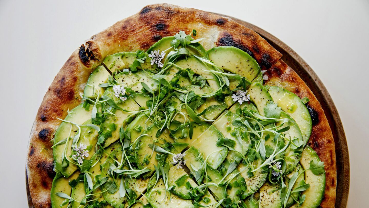 An avacado carpaccio pizza made with jalapenos, cilantro and lime are among the dishes served at the Waldorf Astoria Beverly Hills.