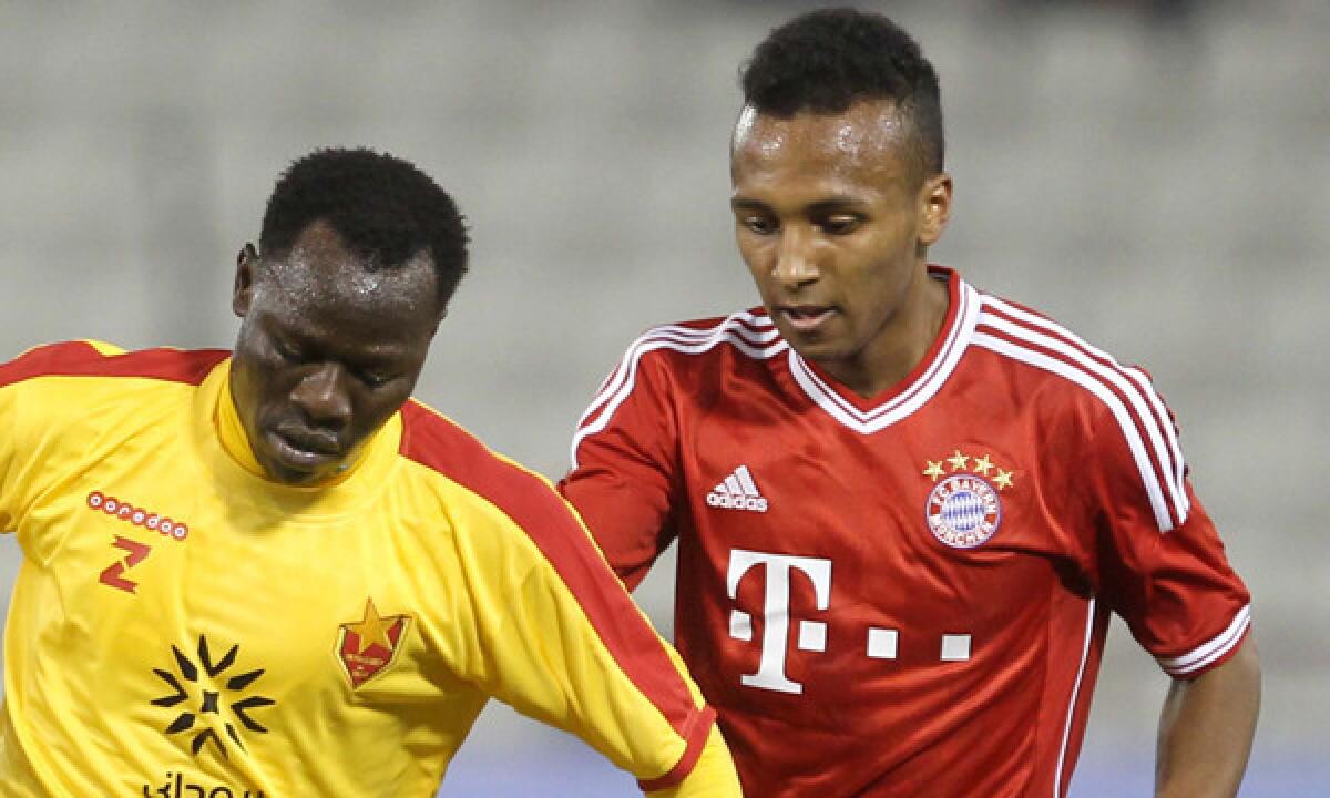 Bayern Munich's Julian Green, right, defends against Al-Merrikh's Balla Jabir during a friendly match in Doha, Qatar, in January. Green has applied to represent the United States in international competition, U.S. Coach Juergen Klinsmann says.