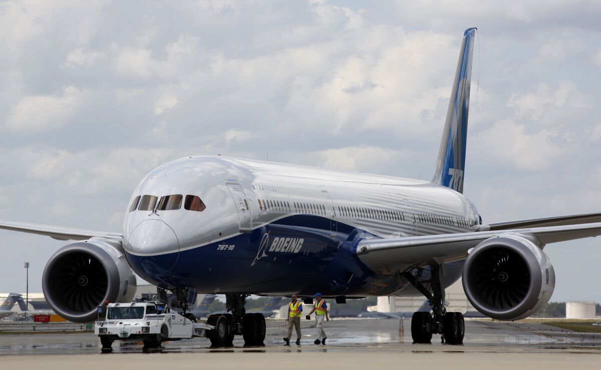 FILE - In this Friday, March 31, 2017, file photo, Boeing employees walk the new Boeing 787-10 Dreamliner down towards the delivery ramp area at the company's facility in South Carolina after conducting its first test flight at Charleston International Airport in North Charleston, S.C. Federal safety officials aren't ready to give back authority for approving new planes to Boeing when it comes to the large 787 jet, which Boeing calls the Dreamliner, Tuesday, Feb. 15, 2022. The plane has been plagued by production flaws for more than a year.(AP Photo/Mic Smith, File)
