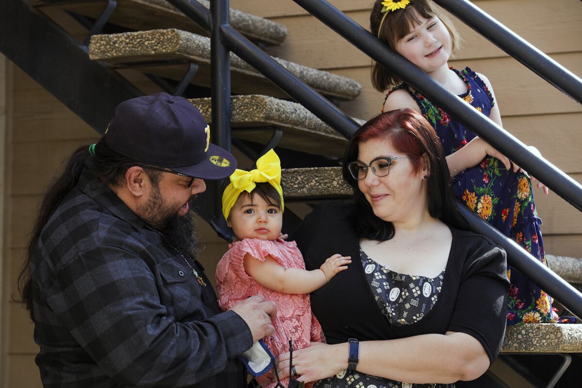 UC Riverside student Yvonne Marquez, 36, center, with her husband Gilbert Marquez and daughters Vivian and Ramona.