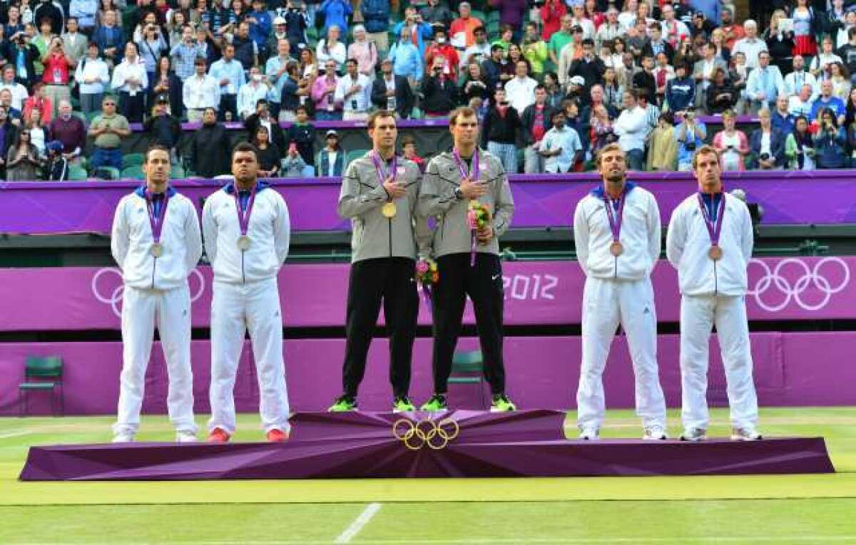 Bob and Mike Bryan, center, on the victory stand after winning the gold medal.