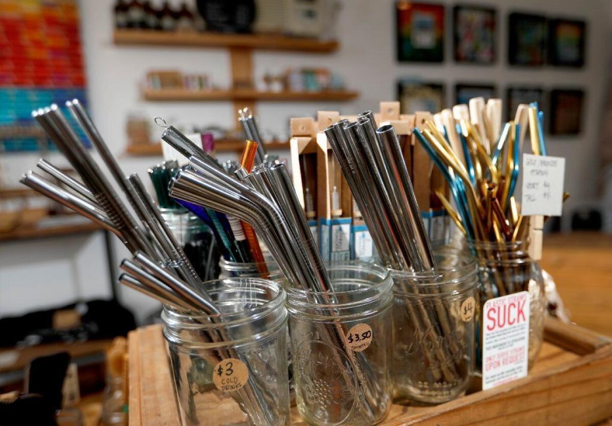 Reusable straws made of metal, wood and glass for sale at the BYO Long Beach store.
