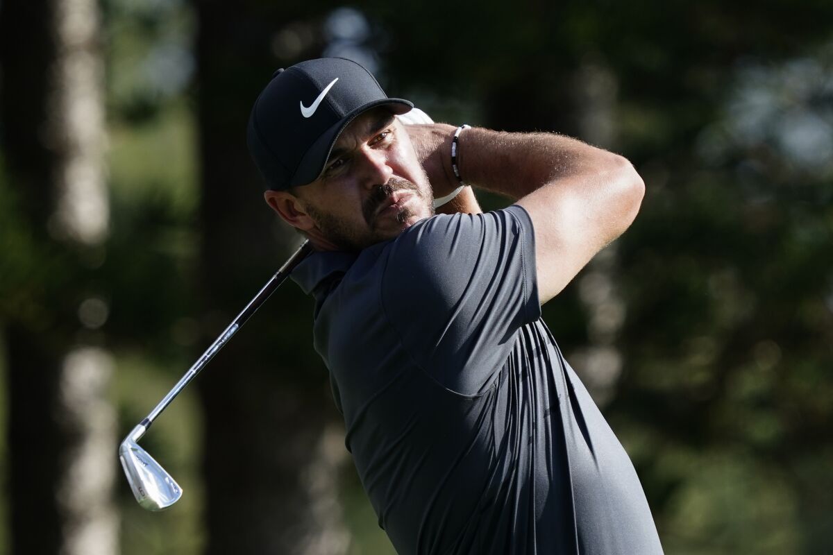 Brooks Koepka watches his tee shot on the second hole during the first round of the Tournament of Champions golf event, Thursday, Jan. 6, 2022, at Kapalua Plantation Course in Kapalua, Hawaii. (AP Photo/Matt York)
