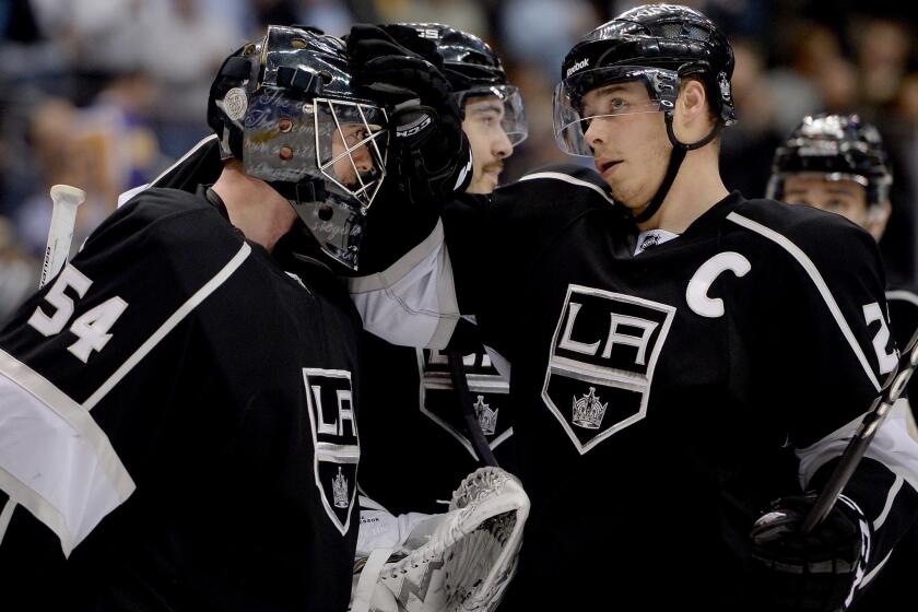Kings goalie Ben Scrivens is congratulated by team captain Dustin Brown following a win over the Tampa Bay Lightning on Tuesday. Scrivens has performed well since taking over for injured starting goalie Jonathan Quick.
