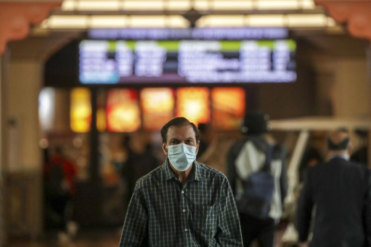 A man wears a mask in Union Station.